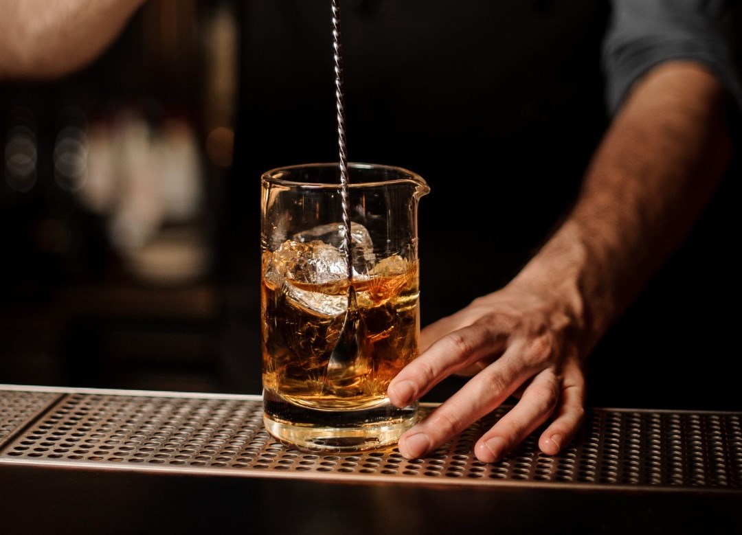 bartender stirring a cocktail