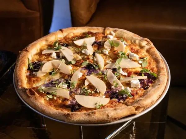 My Boy Blue Pizza topped with sliced pear, blue cheese and greens