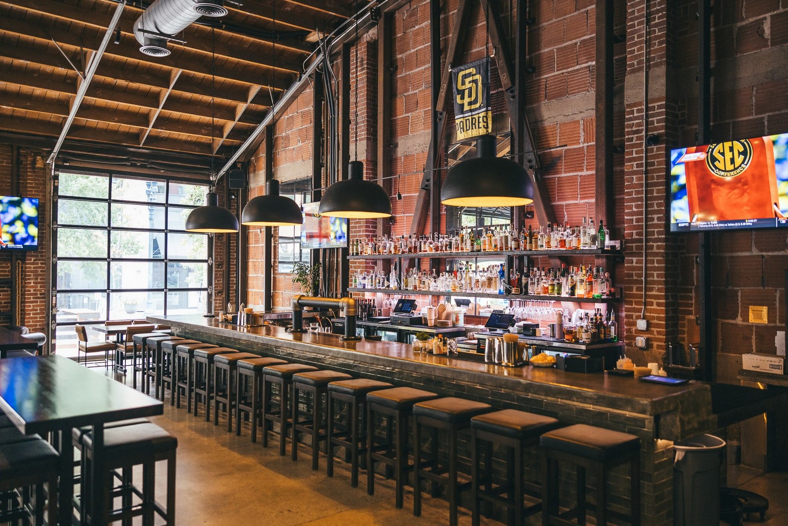 Brick-walled bar with TVs at an East Village sports bar in downtown San Diego