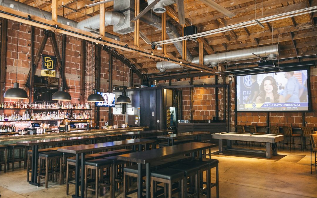 Far Corner dining room with communal tables and TVs - Far Corner