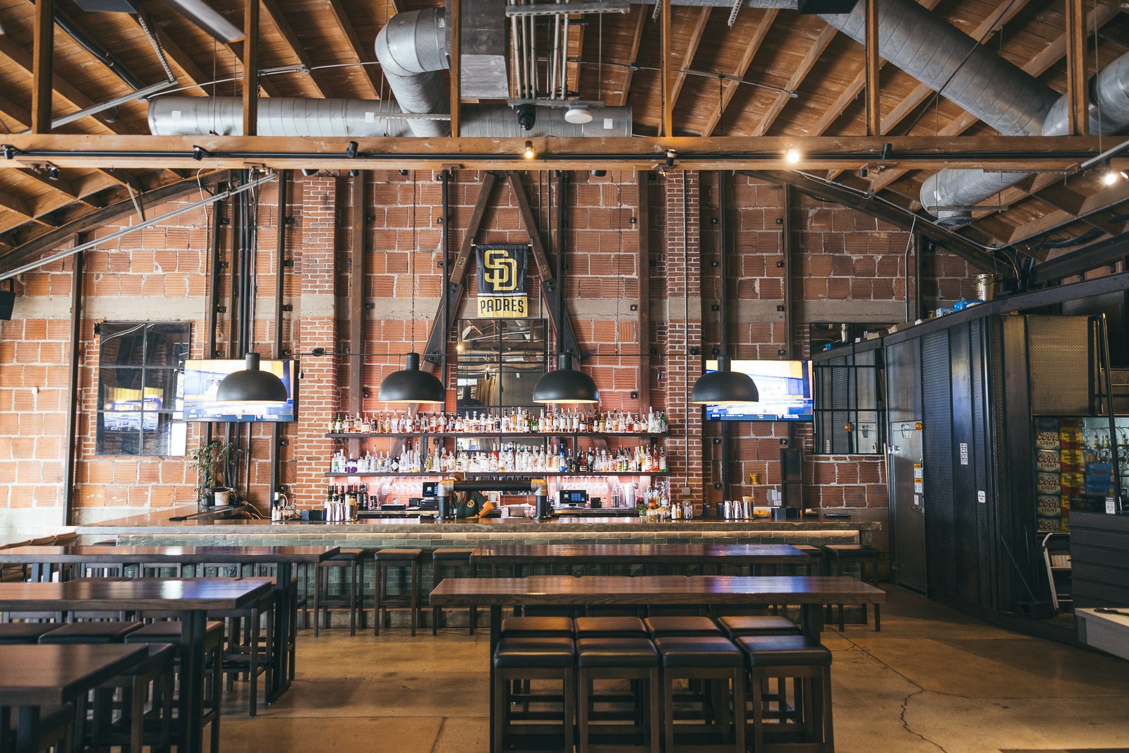 Dining hall with exposed brick and beams at Far Corner, East Village San Diego Dining hall with exposed brick and beams at Far Corner, East Village San Diego