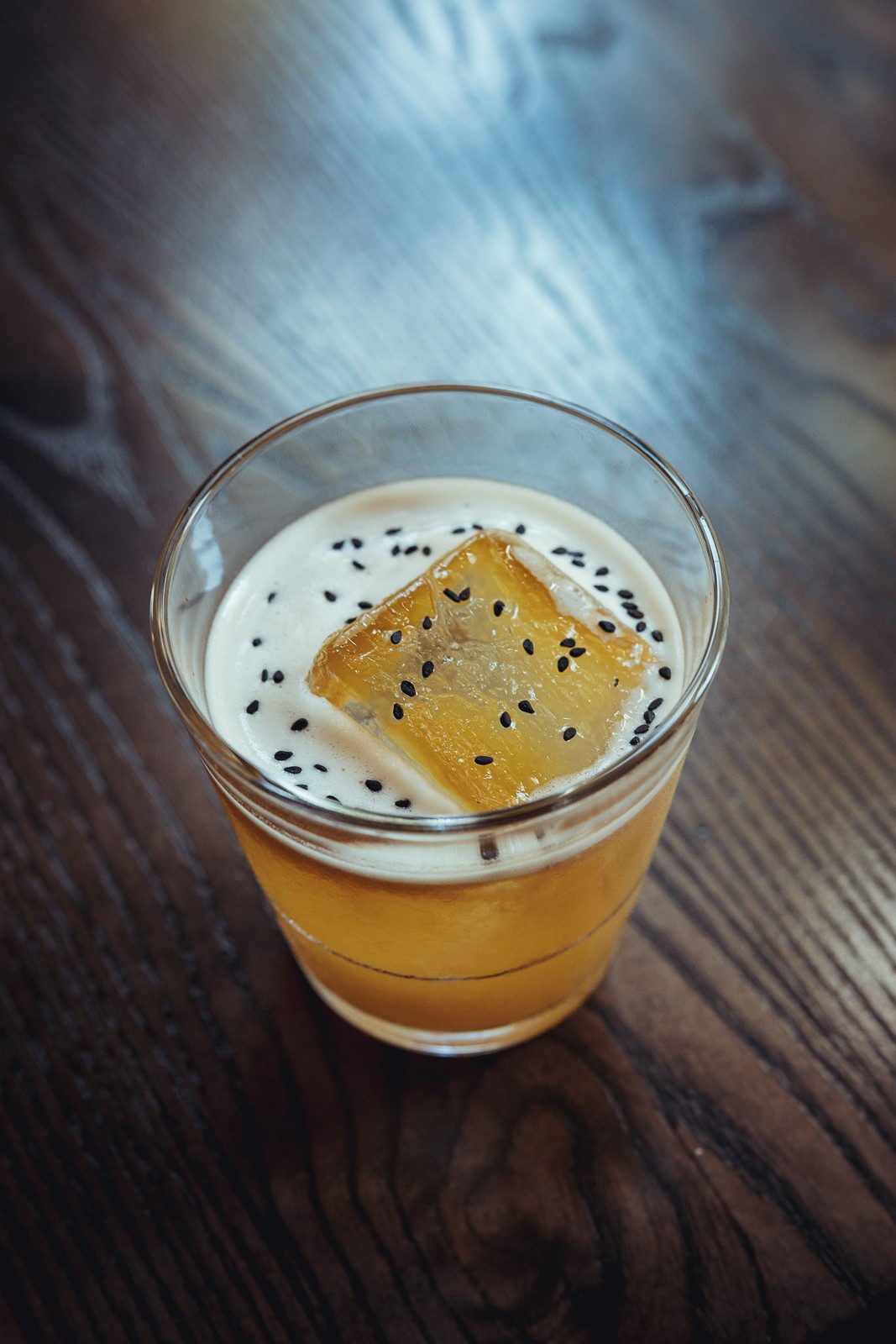 Whiskey sour cocktail with sesame garnish - Far Corner